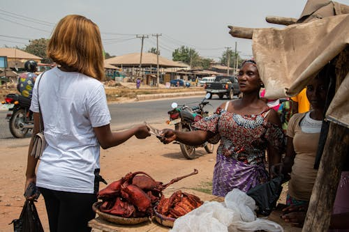 Women vendor and customer at a local roadside market